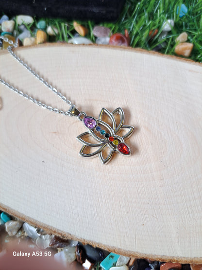 Silver lotus flower pendant necklace with colorful chakra stones.